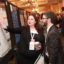 A poster presenter discusses her work with an attendee. Ninety posters were featured at this year&#39;s conference.